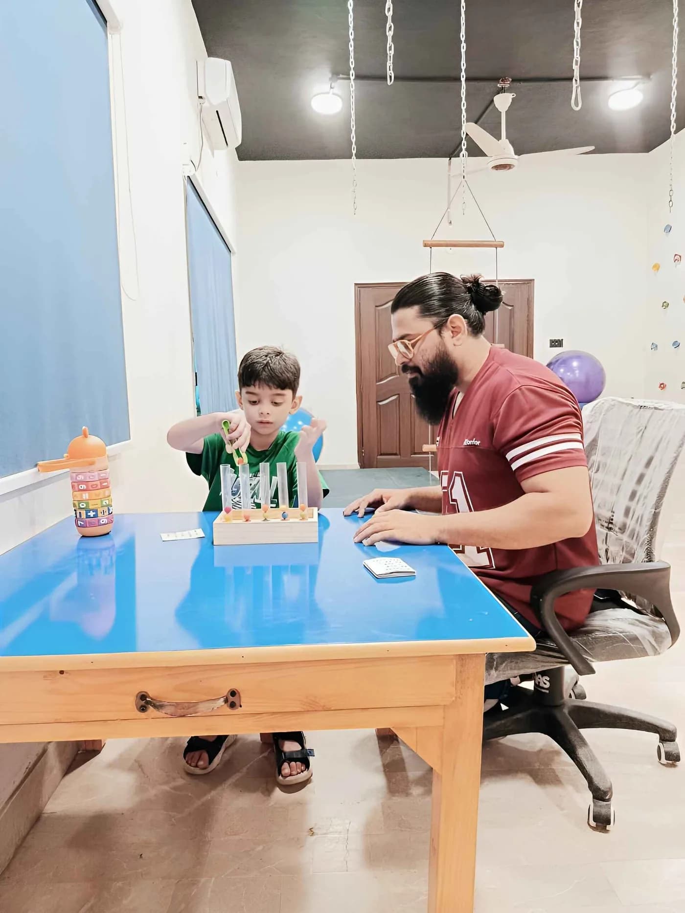 A teacher and child working together at a table
