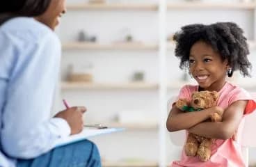 A therapist working one-to-one with a child