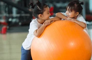 Children playing with a large exercise ball